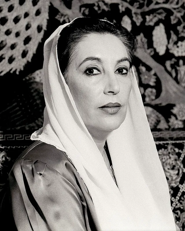 Photographic portrait of Benazir Bhutto wearing a white headscarf.