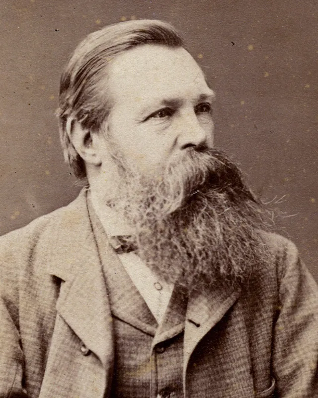 Photographic portrait of Friedrich Engels with a trimmed beard, in a dark jacket.
