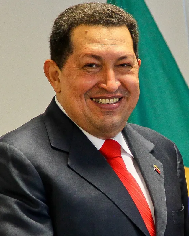 Photograph of Hugo Chávez in a suit with a red tie, 2011.