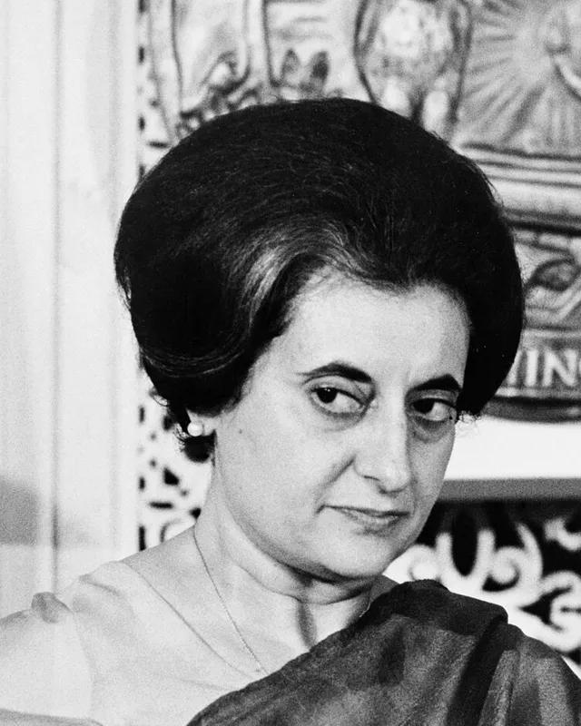 Photograph of Indira Gandhi in 1966, in a sari, looking toward the camera.