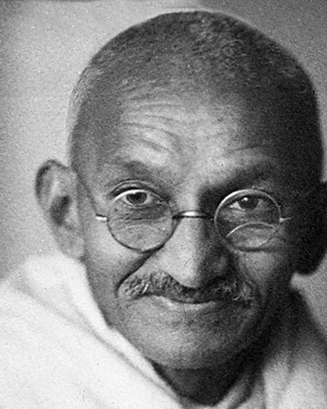 Studio photograph of Mahatma Gandhi in 1931, seated in a shawl, looking toward the camera.