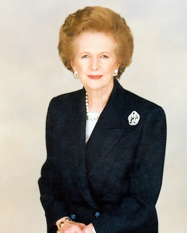Official portrait photograph of Margaret Thatcher in a dark jacket with pearls.