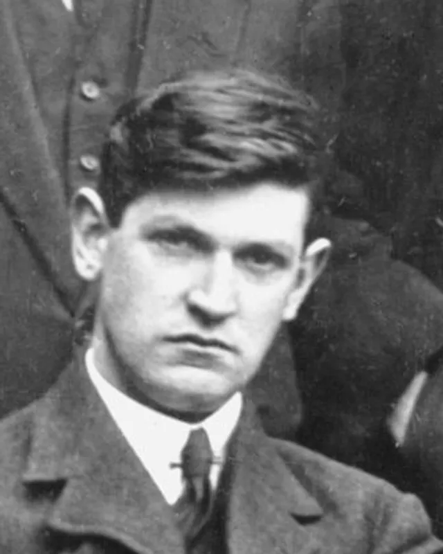 Photographic portrait of Michael Collins in a suit.