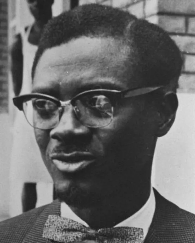 Photographic portrait of Patrice Lumumba in glasses and bow tie, 1960.