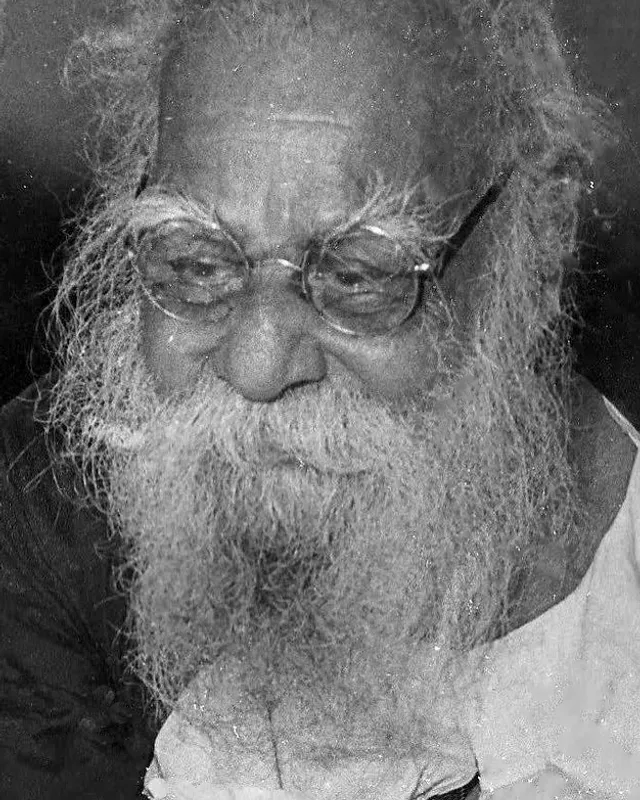 Photograph of Periyar E. V. Ramasamy with a white beard and dark glasses.