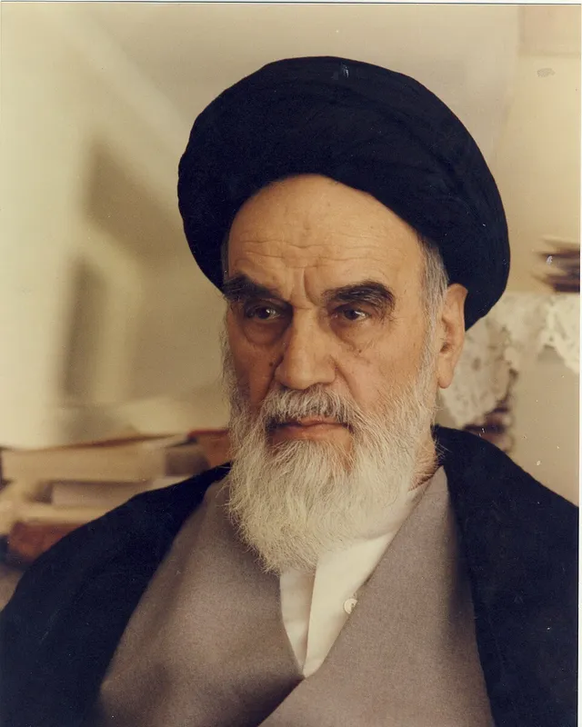 Photographic portrait of Ruhollah Khomeini in a black turban.