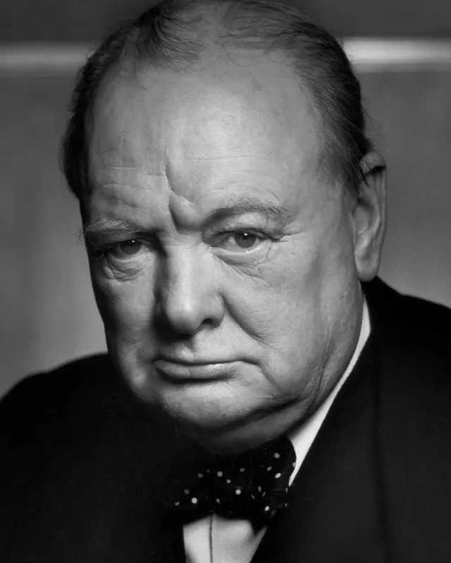 Photographic portrait of Winston Churchill in a dark suit and bow tie.
