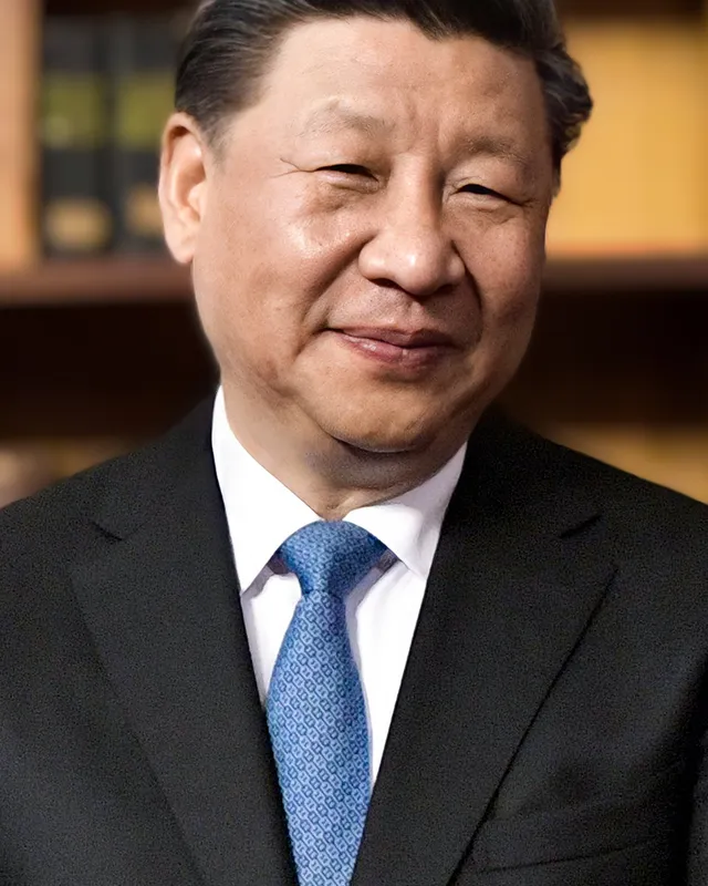 Portrait photograph of Xi Jinping in a dark suit and red tie.